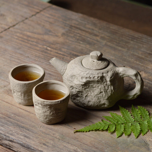 Un pot et deux tasses de céramique artisanale en grès et argile